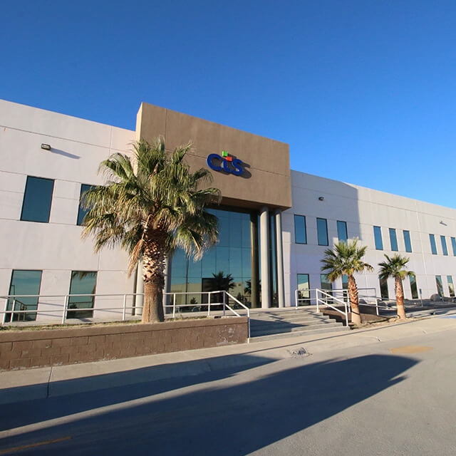 CTS facility with large palm tree and blue sky located in Juarez, Mexico