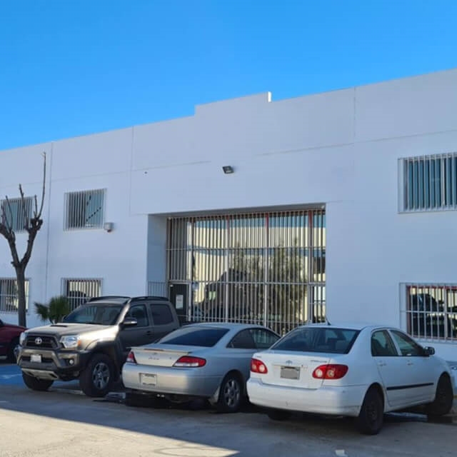 CTS facility with cars parked in front with blue sky located in Tecate, Mexico