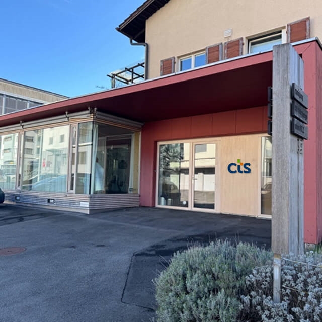 CTS office with red and tan colored siding located in Zug, Switzerland